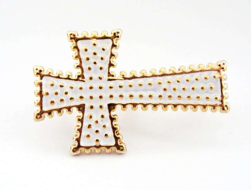Anel dourado com formato de cruz branca